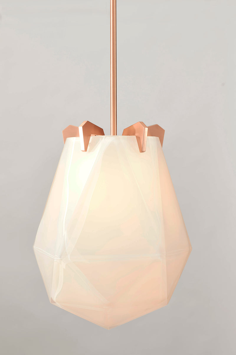 A powerful warm light diffused through double-blown glass, the Briolette Small Pendant showcases striking prismatic contours held by the brand’s signature metallic prongs.