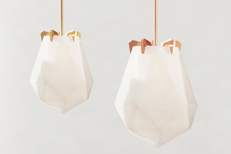 A powerful warm light diffused through double-blown glass, the Briolette Small Pendant showcases striking prismatic contours held by the brand’s signature metallic prongs.
