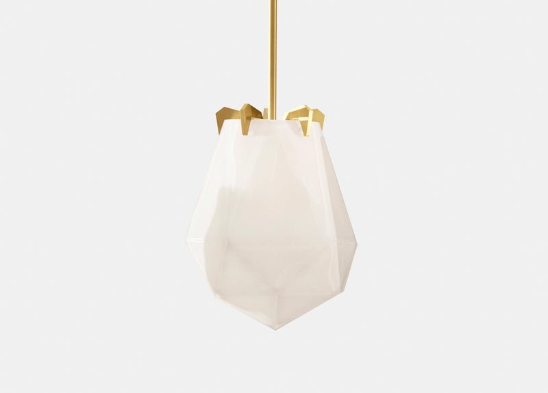 A powerful warm light diffused through double-blown glass, the Briolette Small Pendant showcases striking prismatic contours held by the brand’s signature metallic prongs.