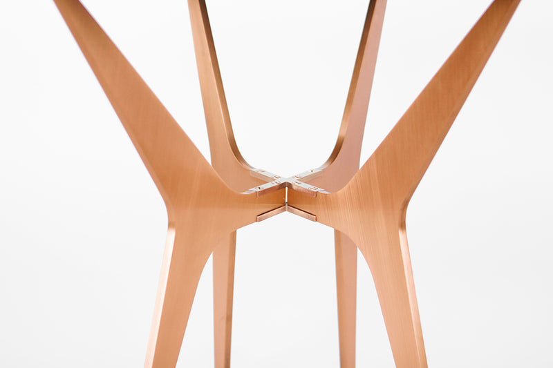 The luxurious Dean Oval Side Table is inspired by mid-century modern design but with a minimalist metallic structure softened by the rounded edges of the sleek glass top.