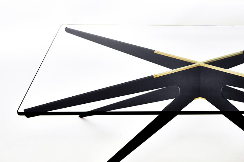 Fusing industrial design with elegant lines, the Dean Rectangular Coffee Table combines a minimalist metallic base with a glass top to exude a versatile silhouette to perfectly complement any living space.