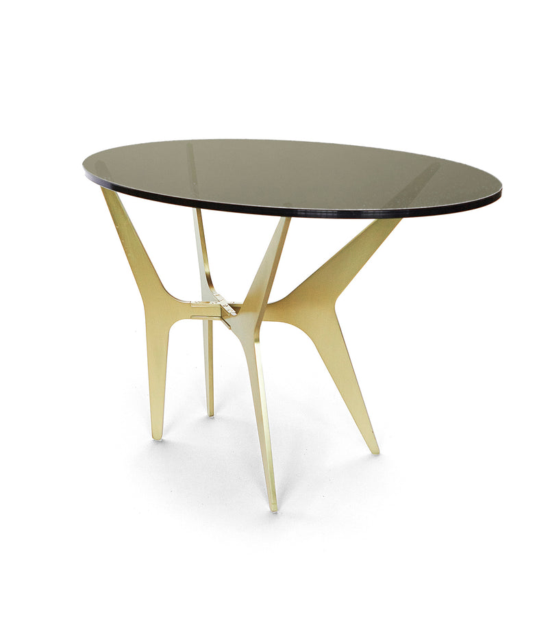 The luxurious Dean Oval Side Table is inspired by mid-century modern design but with a minimalist metallic structure softened by the rounded edges of the sleek glass top.