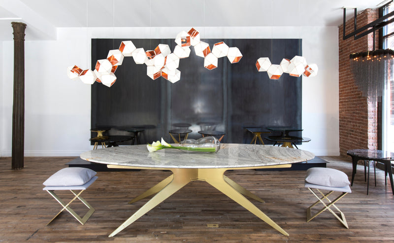 Showcasing contemporary industrial design met with elegant lines, the DEAN Dining Table features Italian and Turkish marbles set atop its layered metallic legs.