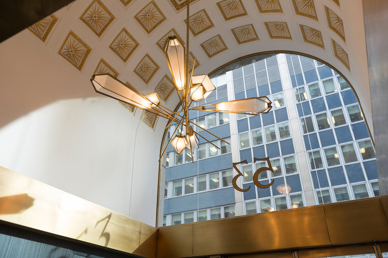 A veritable showstopper, the Harlow Large Chandelier offers luxury in an elegant starburst of light that reflects and refracts through its mold-blown glass shade. Not only designed as a contemporary steel chandelier this made-to-order lighting fixture is also available in bronze, copper, nickel and brass.