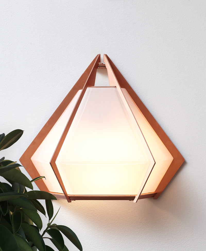 The Harlow wall sconce is an elegant sculptural handmade light fixture inspired by jewelry design featuring a mold-blown glass gem in a chic metallic setting. Created by contemporary designer, Gabriel Scott, the Harlow wall sconce is luxury wall lighting for both bedroom and living room.