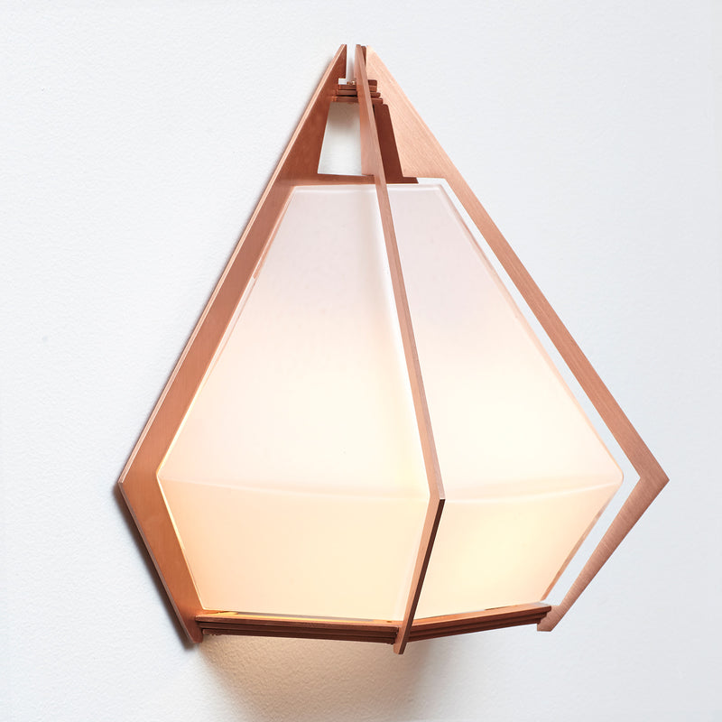 The Harlow wall sconce is an elegant sculptural handmade light fixture inspired by jewelry design featuring a mold-blown glass gem in a chic metallic setting. Created by contemporary designer, Gabriel Scott, the Harlow wall sconce is luxury wall lighting for both bedroom and living room.