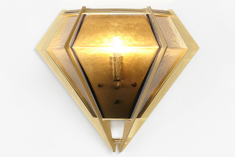 The Harlow wall sconce is an elegant sculptural handmade light fixture inspired by jewelry design featuring a mold-blown glass gem in a chic metallic setting. Created by contemporary designer, Gabriel Scott, the Harlow wall sconce is luxury wall lighting for both bedroom and living room.