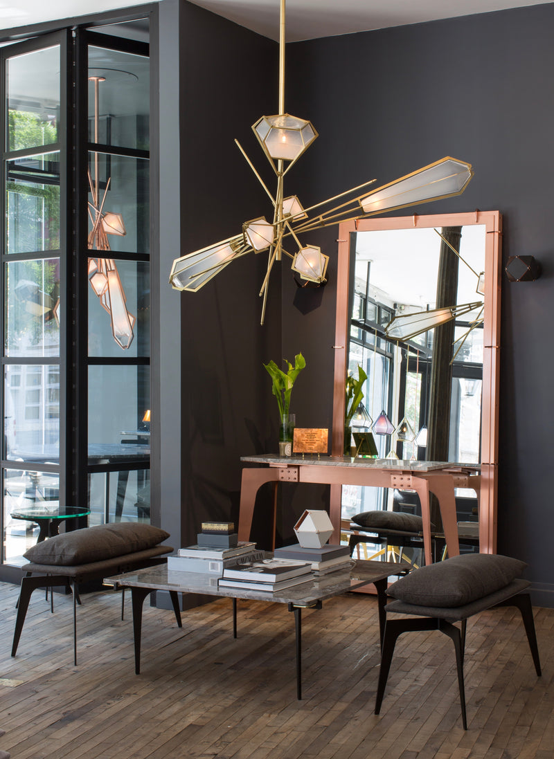 The Harlow Chandelier is directly inspired by the world of jewelry with its metallic frame encasing a translucent glass adding a touch of glamor to any residential or hospitality space.