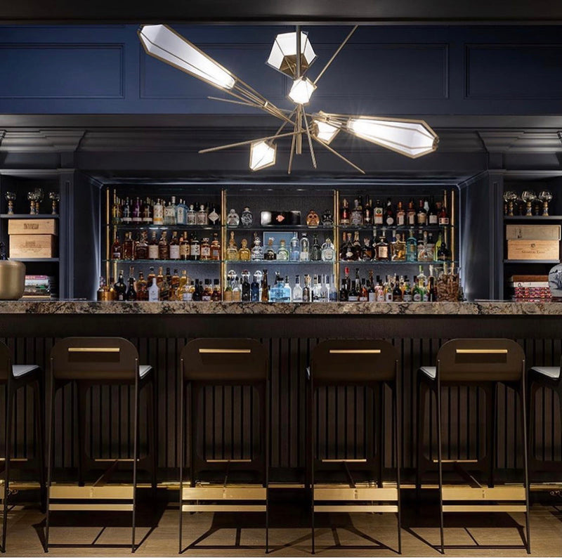 The Harlow Chandelier is directly inspired by the world of jewelry with its metallic frame encasing a translucent glass adding a touch of glamor to any residential or hospitality space.