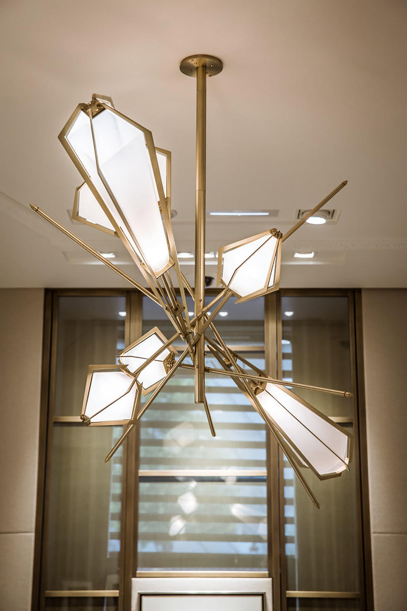 A veritable showstopper, the Harlow Large Chandelier offers luxury in an elegant starburst of light that reflects and refracts through its mold-blown glass shade. Not only designed as a contemporary steel chandelier this made-to-order lighting fixture is also available in bronze, copper, nickel and brass.