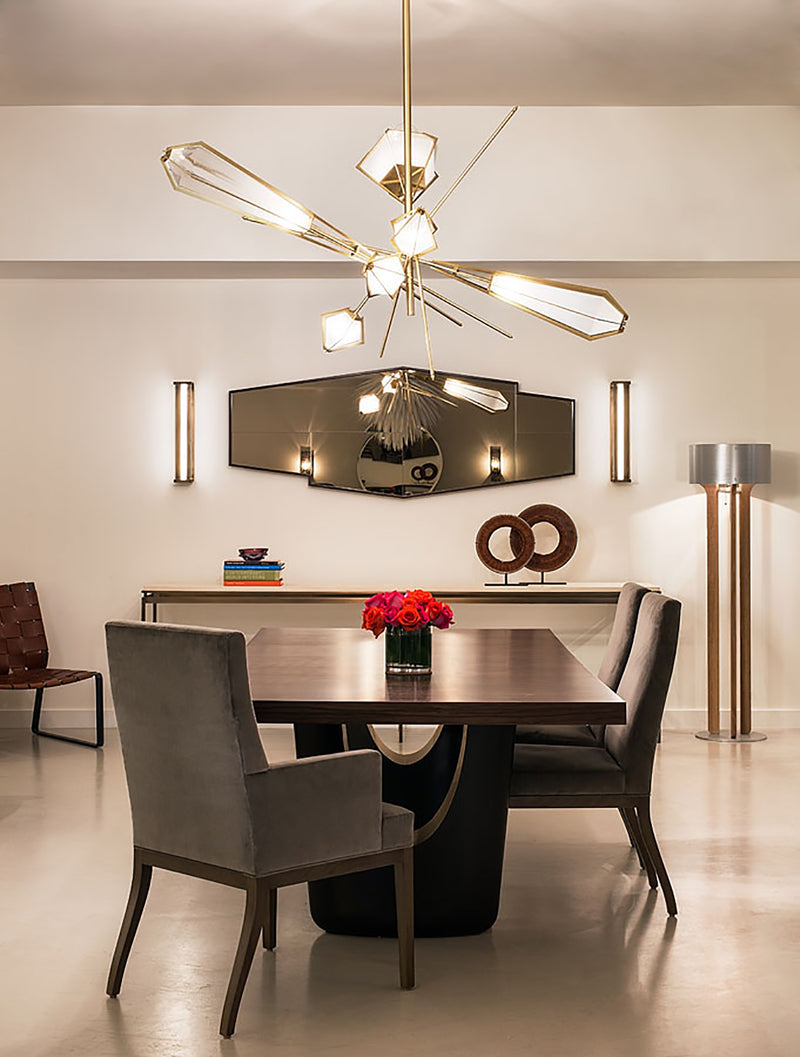 The Harlow Chandelier is directly inspired by the world of jewelry with its metallic frame encasing a translucent glass adding a touch of glamor to any residential or hospitality space.