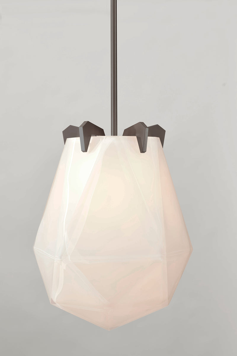 A powerful warm light diffused through double-blown glass, the Briolette Small Pendant showcases striking prismatic contours held by the brand’s signature metallic prongs.