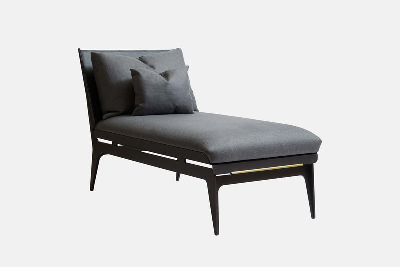 Designer Gabriel Scott plays with rounded metal lines and layering effects to create the Boudoir Chaise Longue. A French pebbled vegan leather lining hosts a plush tone-on-tone fabric cushion sitting on top of the curved metal shell.