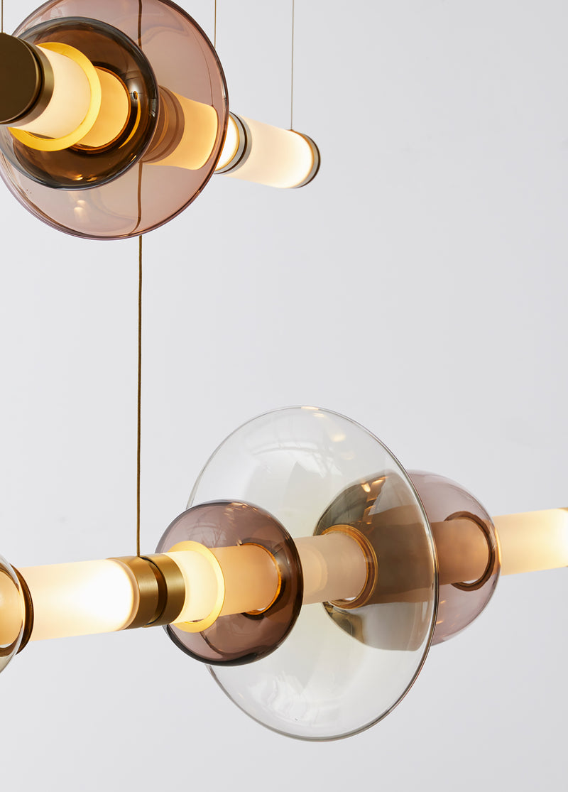 The Luna Chandelier 2-tier is a modern glass chandelier and a perfect statement piece for anywhere within the home or hospitality space. An opportunity to create a unique and enticing lighting solution, as it encompasses a modular design format, this light is customisable to your choices to create a bespoke chandelier.