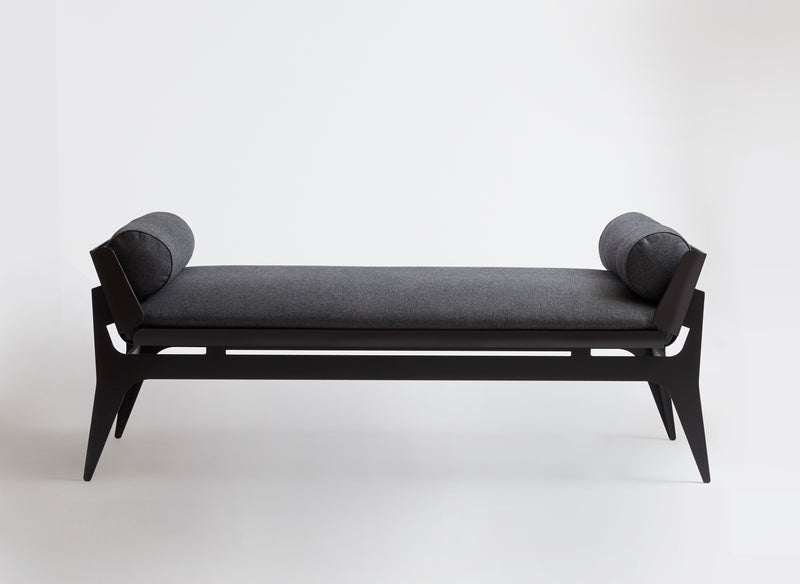 A classic seating silhouette reinterpreted, Gabriel Scott plays with rounded metal lines and layering effects to create the Boudoir Daybed. A French pebbled vegan leather lining hosts a plush tone-on-tone fabric cushion sitting on top of the curved metal shell, fusing solid with soft.