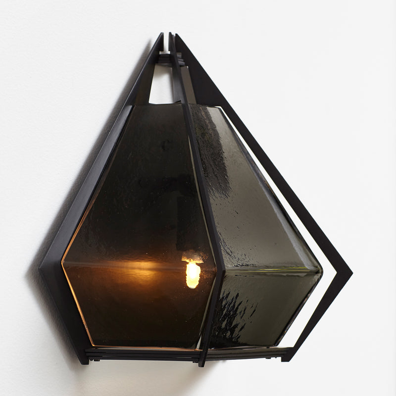 The Harlow wall sconce is an elegant sculptural handmade light fixture inspired by jewelry design featuring a mold-blown glass gem in a chic metallic setting. Created by contemporary designer, Gabriel Scott, the Harlow wall sconce is luxury wall lighting for both bedroom and living room.