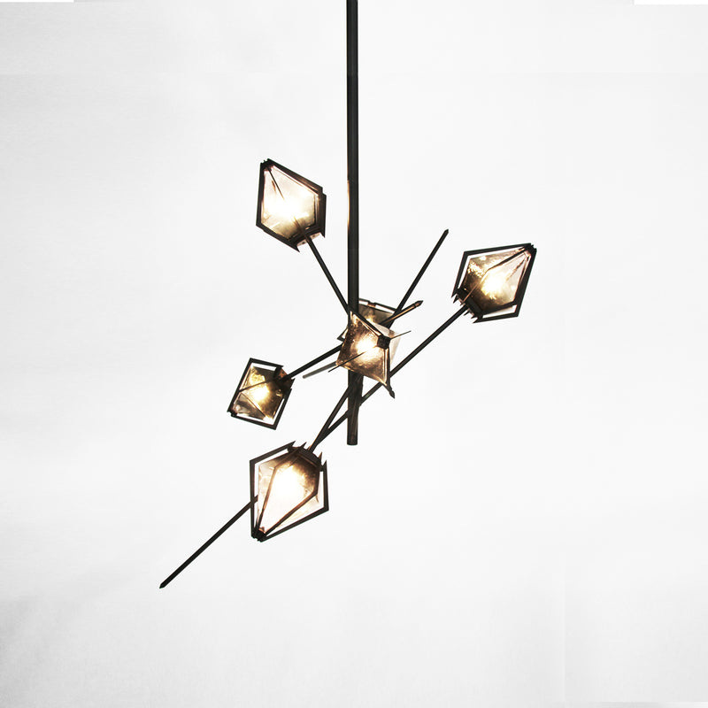 An elegant sculptural luxury lighting fixture, the Harlow Small Chandelier inspired by jewellery design, features a mold-blown glass gem in a chic metallic setting. The blown glass, made to order lighting creates a diffused soft light, with the prong inspired hardware adding glamour to each contemporary light fixture.
