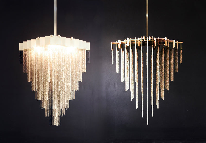 A made to order chandelier that moves with glamorous intrigue, the KELLY Chandelier’s metallic chain cascades through its various layers to create a glisten reflective effect. The epitome of high end lighting, this bespoke chandelier provides a handmade designer lighting solution for luxury interior design.