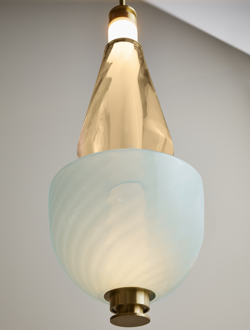 Contemporary lighting designer, Gabriel Scott, takes inspiration from a lunar halo, the Luna Kaleido Large Pendant is a highly customizable modular light fixture which features two textured glass beads covering a white glass tube. This glass pendant lighting provides a luxury lighting fixture solution for high end interior design.