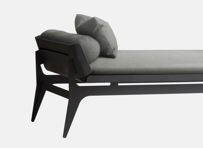 A classic seating silhouette reinterpreted, Gabriel Scott plays with rounded metal lines and layering effects to create the Boudoir Daybed. A French pebbled vegan leather lining hosts a plush tone-on-tone fabric cushion sitting on top of the curved metal shell, fusing solid with soft.
