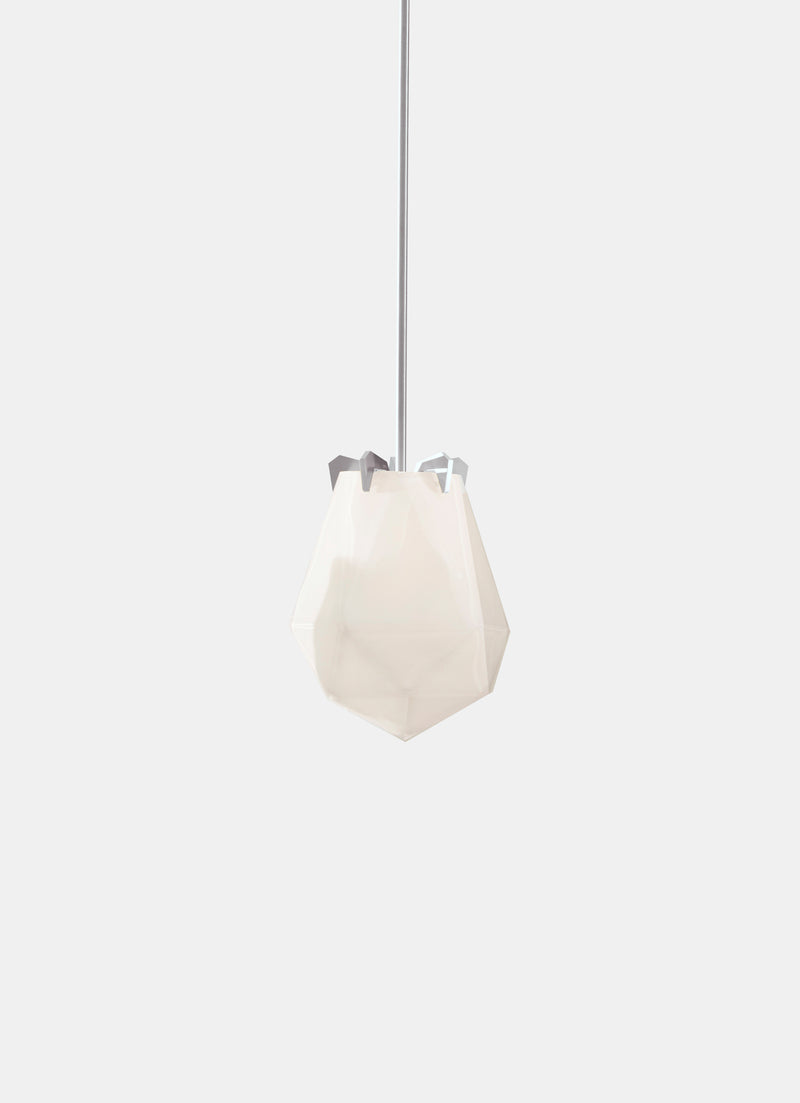 A powerful warm light diffused through double-blown glass, the Briolette Small Pendant showcases striking prismatic contours held by the brand’s signature metallic prongs.