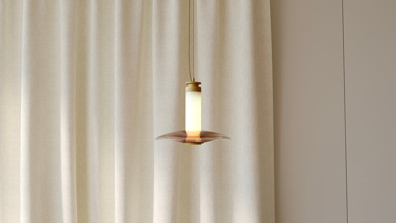 The Luna A Small Disc Pendant creates an allusive play of light through various gradients of coloured glass. This luxury pendant by contemporary lighting designer, Gabriel Scott, provides a high end light fitting for modern interior design.